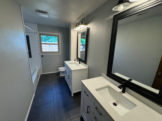 full bathroom with washtub / shower combination, vanity, toilet, and a textured ceiling