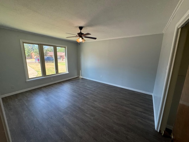 empty room featuring ceiling fan, ornamental molding, dark hardwood / wood-style floors, and a textured ceiling