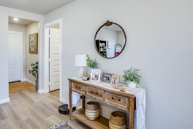 corridor with light hardwood / wood-style floors