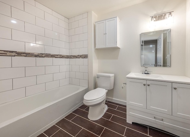 full bathroom with vanity, tiled shower / bath, and toilet