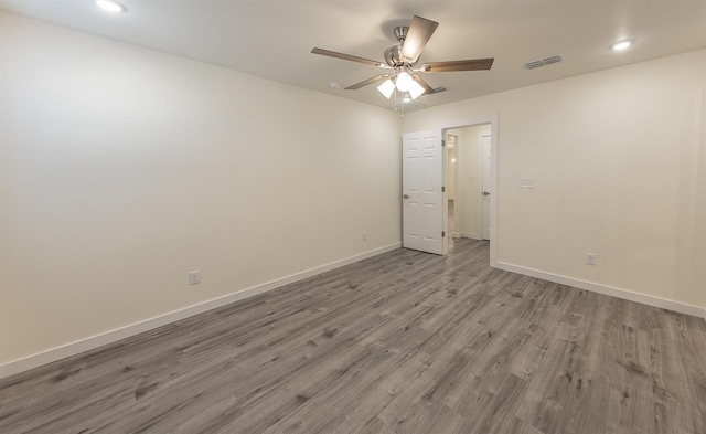 empty room featuring ceiling fan and light hardwood / wood-style flooring