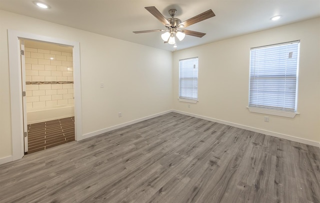 unfurnished room with hardwood / wood-style floors and ceiling fan