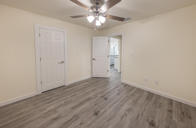 unfurnished bedroom with ceiling fan and light hardwood / wood-style flooring