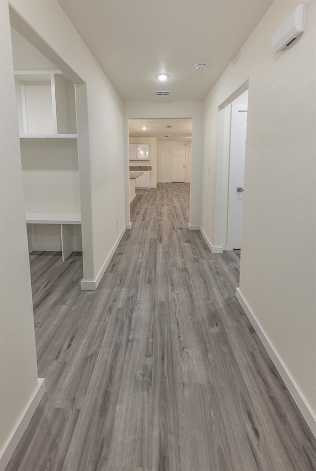 hallway with light hardwood / wood-style floors