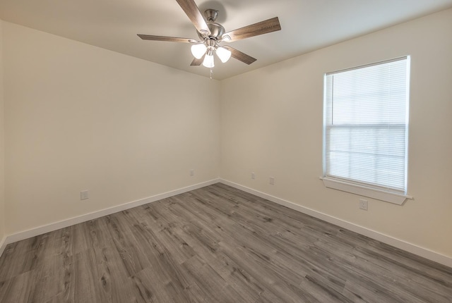 spare room featuring ceiling fan and dark hardwood / wood-style flooring