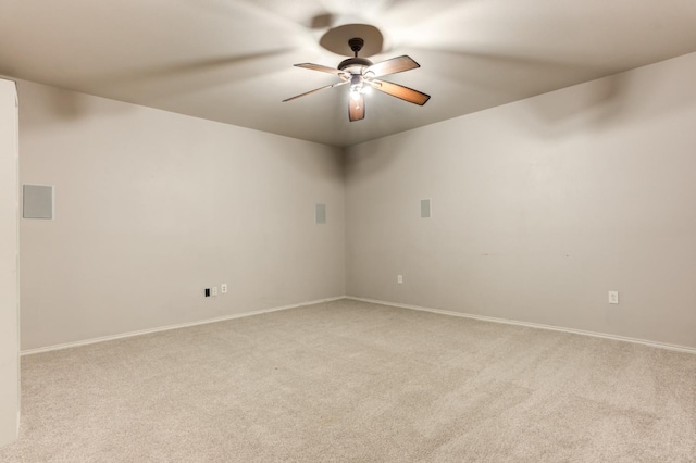 spare room with ceiling fan and light colored carpet