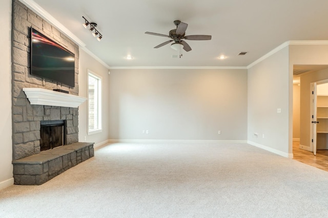 unfurnished living room featuring light carpet, crown molding, a fireplace, and ceiling fan