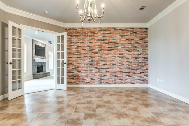 spare room featuring crown molding, brick wall, and french doors