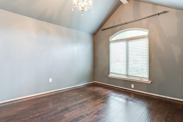 empty room with lofted ceiling, dark wood-type flooring, and an inviting chandelier