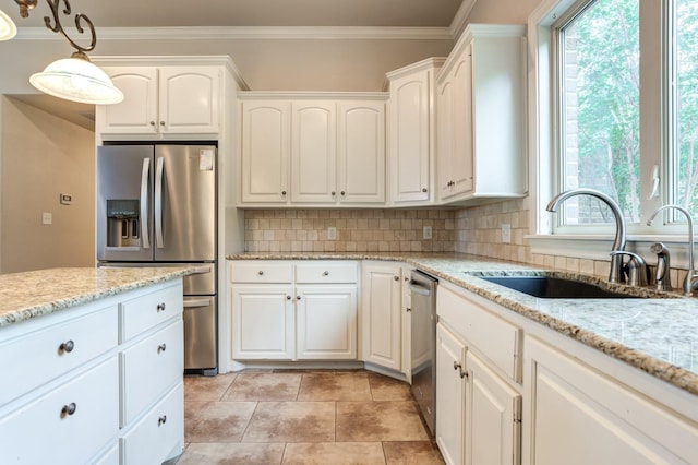 kitchen featuring white cabinetry, stainless steel appliances, decorative light fixtures, and sink