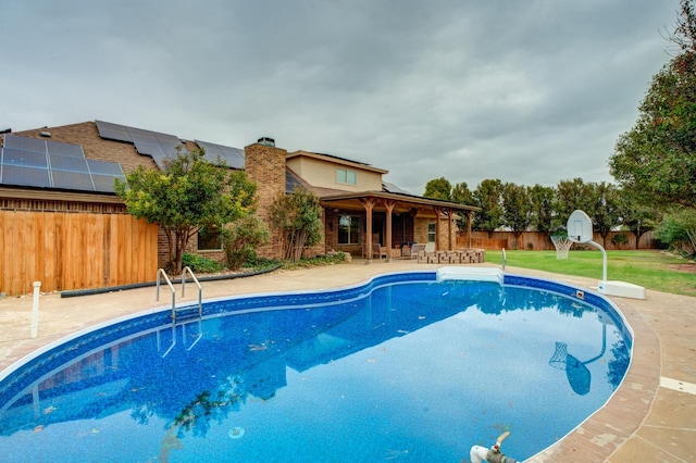 view of swimming pool featuring a patio area