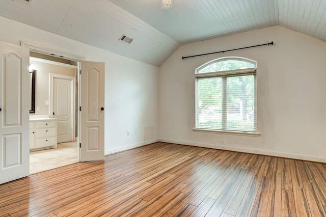 spare room featuring wooden ceiling, lofted ceiling, and light wood-type flooring