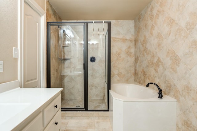 bathroom with vanity, independent shower and bath, and tile walls