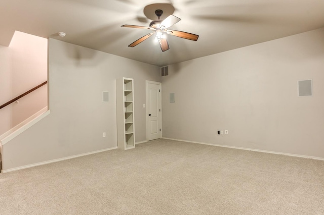 unfurnished room featuring light carpet and ceiling fan