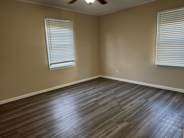 spare room with ceiling fan, ornamental molding, and dark hardwood / wood-style floors