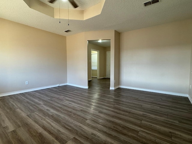 spare room featuring dark hardwood / wood-style floors, a textured ceiling, and ceiling fan