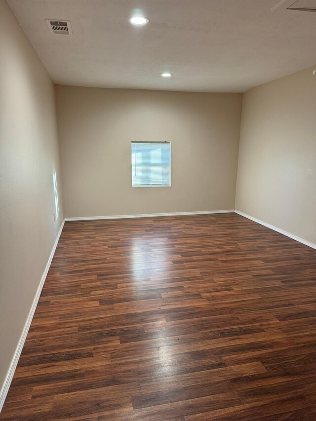 unfurnished room featuring dark wood-type flooring