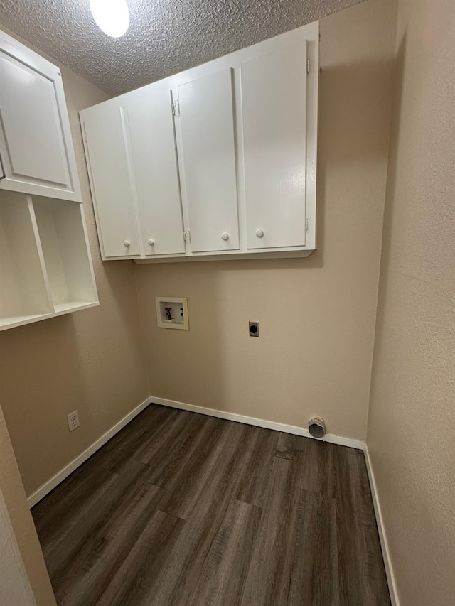 clothes washing area with dark hardwood / wood-style flooring, cabinets, washer hookup, electric dryer hookup, and a textured ceiling