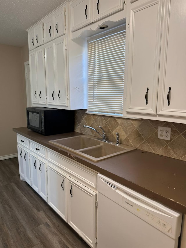 kitchen featuring sink, backsplash, white dishwasher, white cabinets, and dark hardwood / wood-style flooring