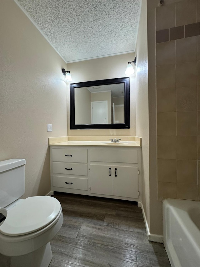 bathroom with vanity, hardwood / wood-style floors, a textured ceiling, and toilet