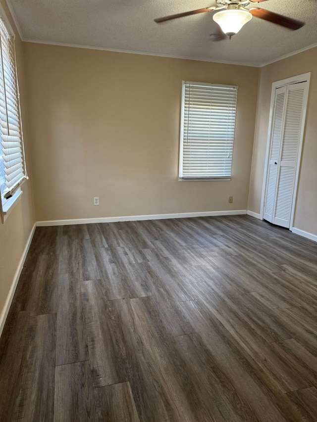 interior space featuring crown molding, a textured ceiling, dark hardwood / wood-style flooring, and a closet