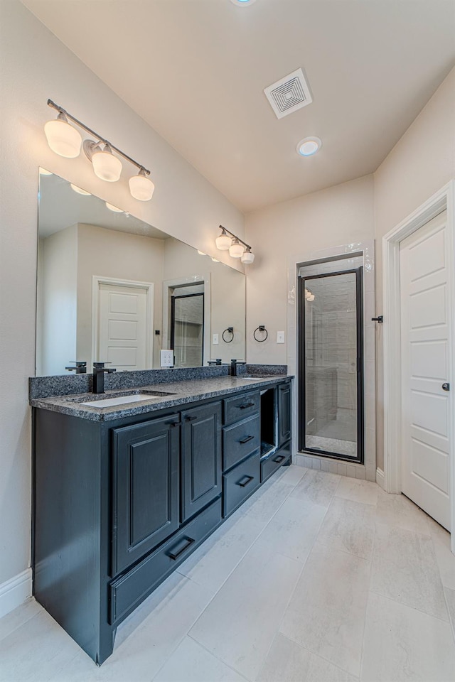 bathroom featuring vanity, an enclosed shower, and tile patterned floors