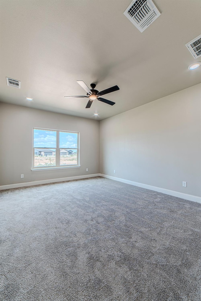 carpeted spare room featuring ceiling fan