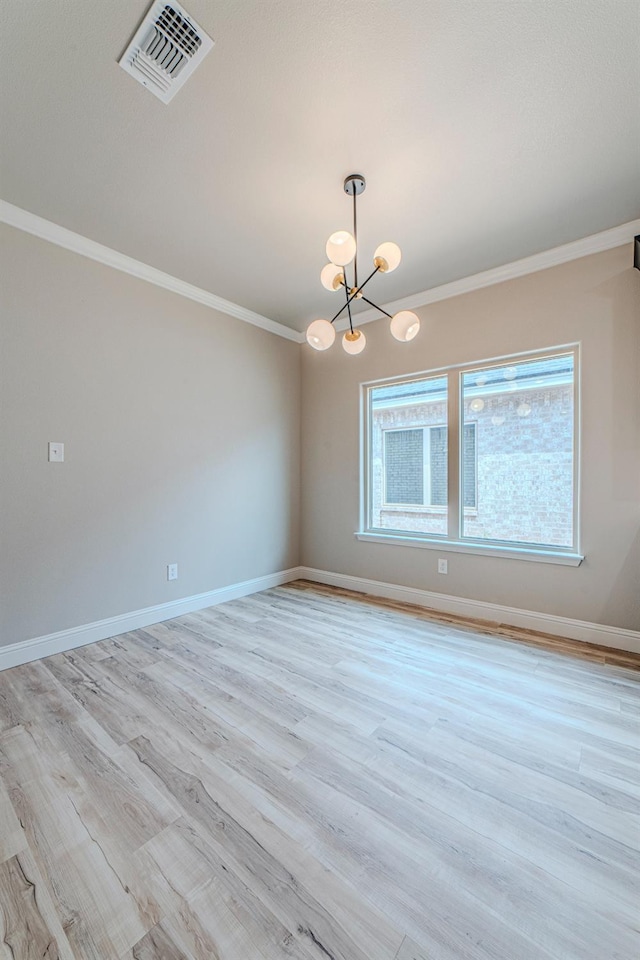 unfurnished room with an inviting chandelier, ornamental molding, and light hardwood / wood-style flooring