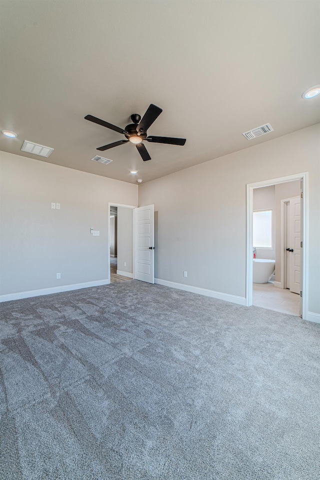 carpeted spare room featuring ceiling fan