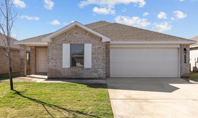 ranch-style house featuring a garage and a front lawn