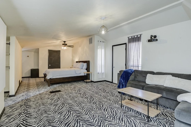 carpeted bedroom with ceiling fan and vaulted ceiling