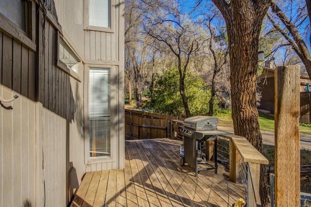 wooden deck with a grill