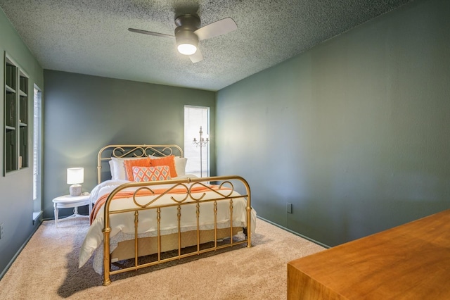 bedroom featuring ceiling fan, carpet flooring, and a textured ceiling