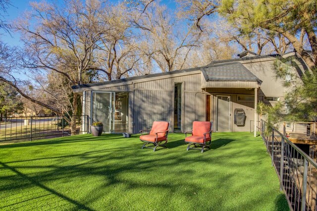 rear view of property with a yard