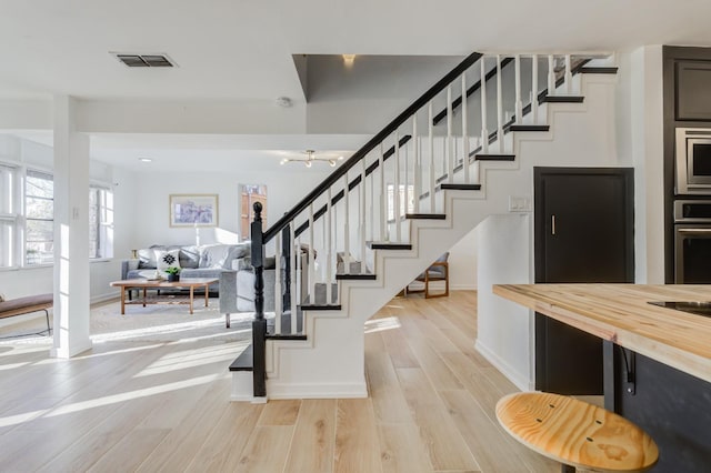 stairs featuring wood-type flooring