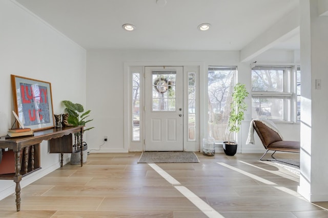 foyer entrance with light hardwood / wood-style floors