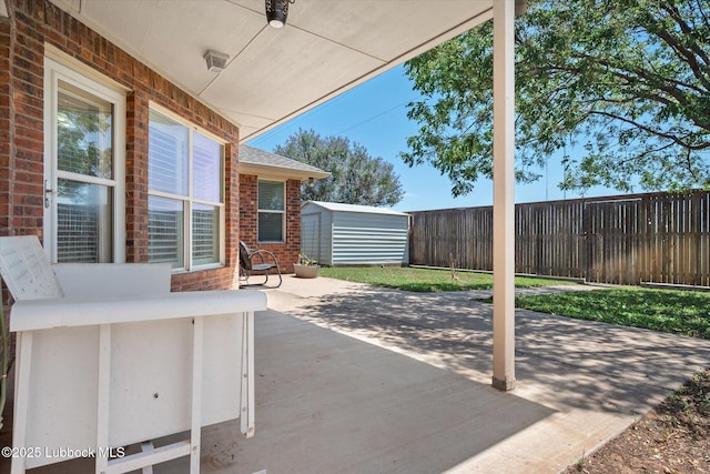 10401 Elgin Ave, Lubbock, TX 79423 - fenced backyard featuring a storage unit and a patio area
