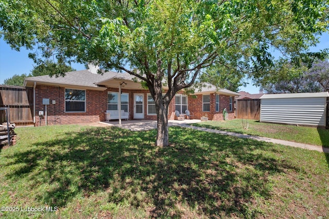 10401 Elgin Ave, Lubbock, TX 79423 - rear view of property with brick siding and a patio area