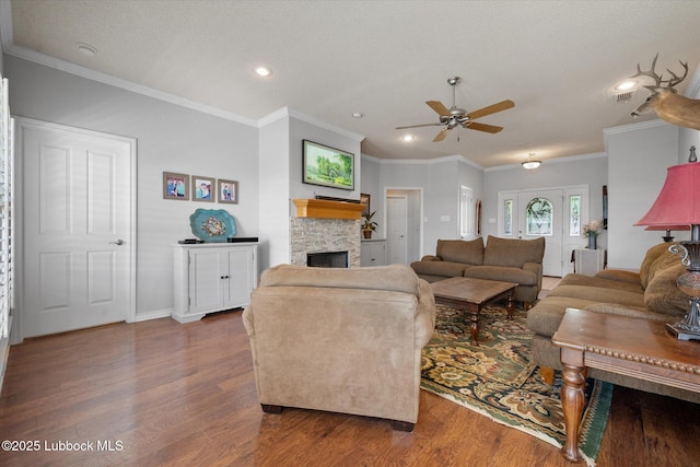 10401 Elgin Ave, Lubbock, TX 79423 - living room with ceiling fan, wood finished floors, a stone fireplace, recessed lighting, and ornamental molding