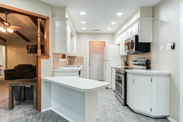 5734 92nd St, Lubbock, TX 79424 - kitchen featuring backsplash, stainless steel appliances, a sink, and a peninsula
