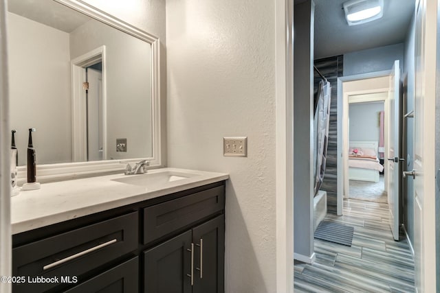 5734 92nd St, Lubbock, TX 79424 - full bath with vanity, a textured wall, and shower / tub combo with curtain