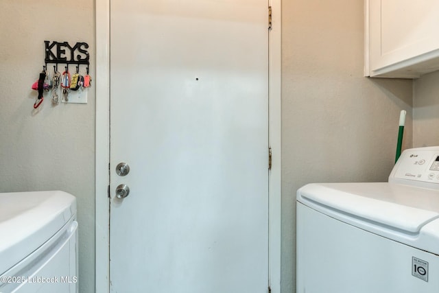5734 92nd St, Lubbock, TX 79424 - laundry area featuring cabinet space and washing machine and dryer