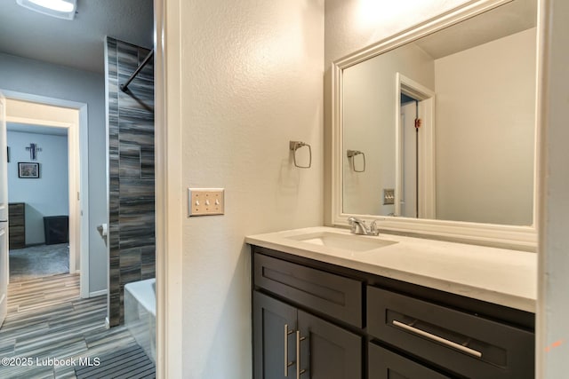 5734 92nd St, Lubbock, TX 79424 - bathroom featuring a textured wall and vanity