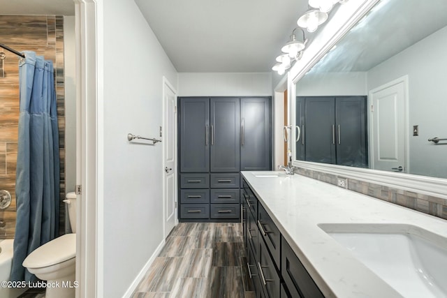 5734 92nd St, Lubbock, TX 79424 - bathroom with double vanity, a sink, baseboards, and toilet