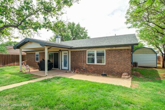 5734 92nd St, Lubbock, TX 79424 - back of property featuring a lawn, brick siding, fence, and a patio
