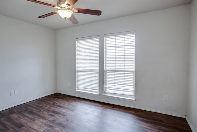 spare room with plenty of natural light, dark hardwood / wood-style floors, and ceiling fan