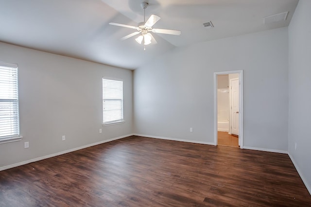 spare room featuring ceiling fan, a healthy amount of sunlight, and dark hardwood / wood-style flooring