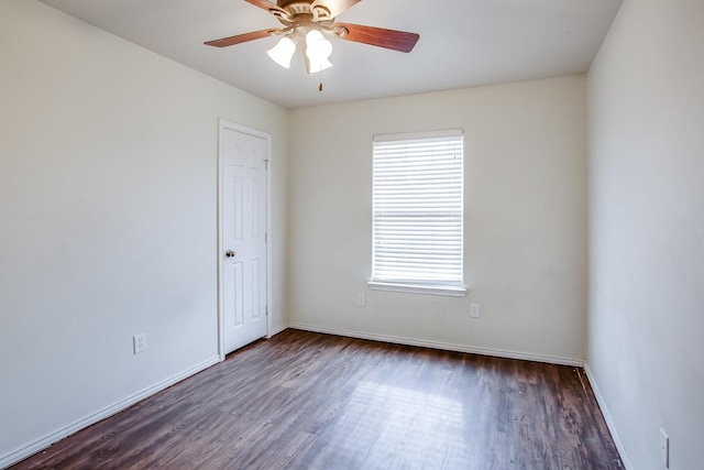 spare room featuring dark hardwood / wood-style floors and ceiling fan