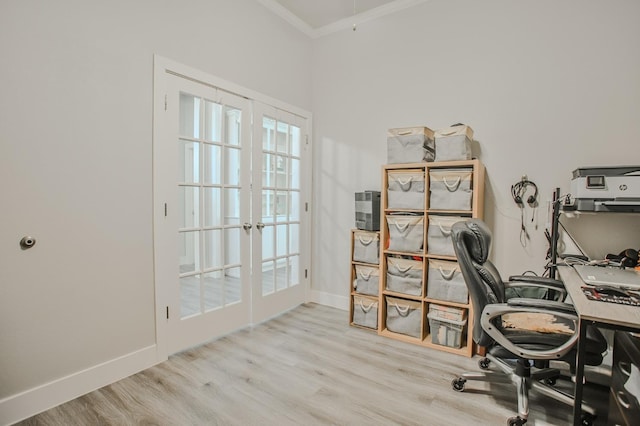 home office featuring crown molding, a wealth of natural light, light hardwood / wood-style flooring, and french doors