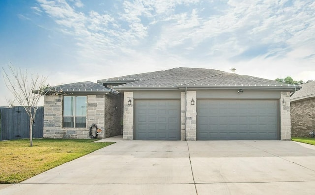 view of front of home with a garage and a front yard